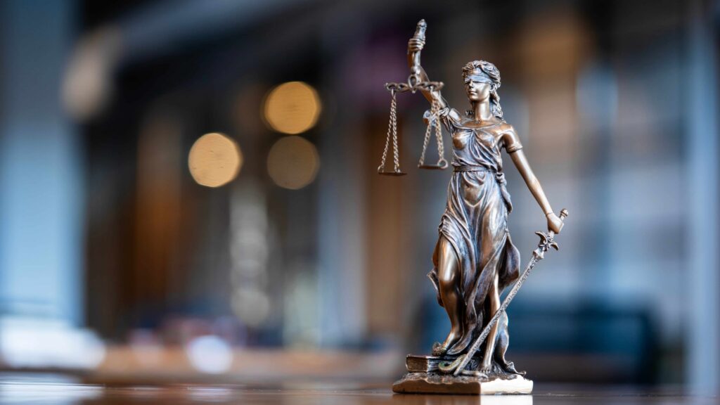 Statue of Lady Justice holding scales and sword, symbol of fairness, balance, and the legal system.