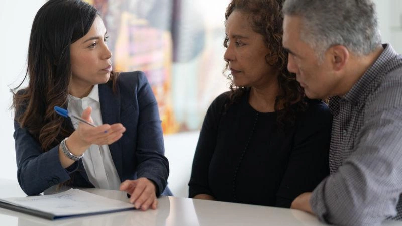 Ethnic Senior Couple With Financial Advisor