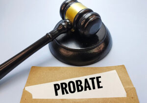 A judge’s gavel sits next to a folder labeled “Probate,” representing probate litigation, estate disputes, and court involvement in administering estates.