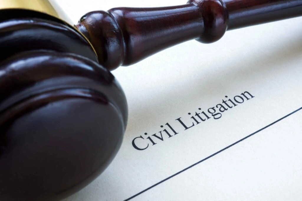 Judge’s gavel resting on a document labeled “Civil Litigation,” symbolizing lawsuit proceedings, legal disputes, and courtroom representation.